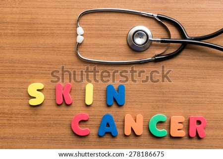 skin cancer  colorful word with stethoscope on wooden background