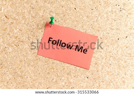 follow me word typed on a paper and pinned to a cork notice board