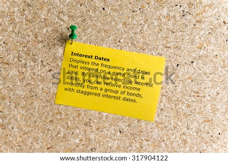 interest dates word typed on a paper and pinned to a cork notice board