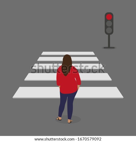 Female character stands in front of a pedestrian crossing and traffic light with red light