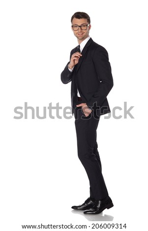 Young attractive business man in black suite on white background.