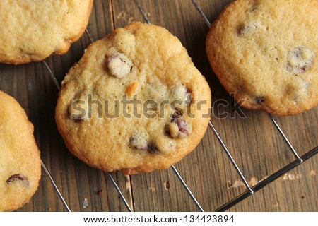 Top view of warm and fresh cookies on a grill on a wooden table