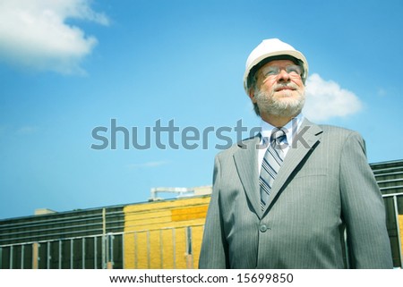 Senior business man and white hard hat