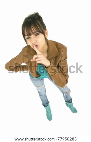 secret teenager with her finger on lips having a secret