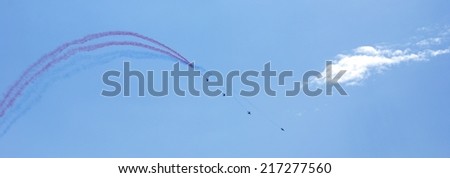 SAINT TROPEZ, PROVENCE, FRANCE - AUGUST 12TH 2014: Group of Jet Fighters Performing Acrobatic Tours During An Event Remembering 70 Years Since D-Day. Smoke Patterns Resemble the French Flag