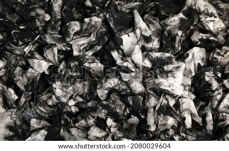 A mass of dirty used cloth wipes covered in black intaglio printers ink. Could be oil dipstick wipes from mechanic. Unique abstract black and white background pattern. Art or printmaking education  Stockfoto © 