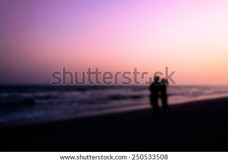 blurred and soft focus of, silhouette of couples hugging on the beach on the beach with sunrise in the sea for valentine\'s day