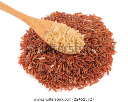 Brown Rice in a wooden spoo and pile of red rice isolated on white background