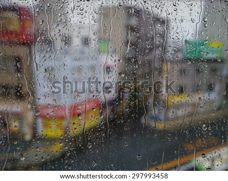 Water drops on a window glass after the rain. View of Buildings in the city.