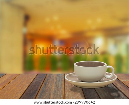 cup of coffee on table in cafe , night light