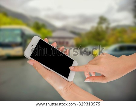 Businessman using smart phone against tree green background