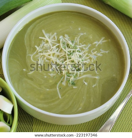 A big bowl of greens with shredded cheese.