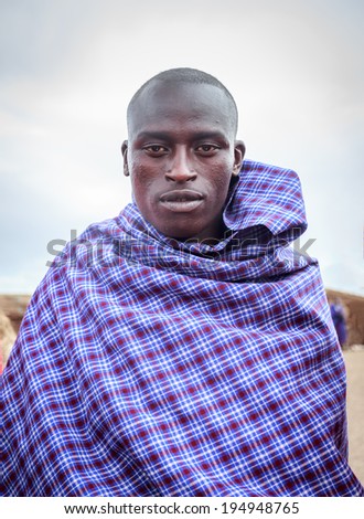 NGORONGORO, TANZANIA - DEC 29, 2013 :Young Masai acting for me to take picture ,when I asked him for one nice shot.