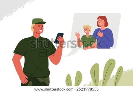 A soldier talks to his wife and child through a video call. Online communication with family while serving in the army.