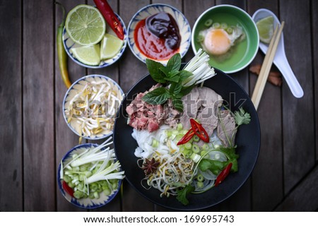 Preparing Vietnamese rice noodles, with beef and other materials