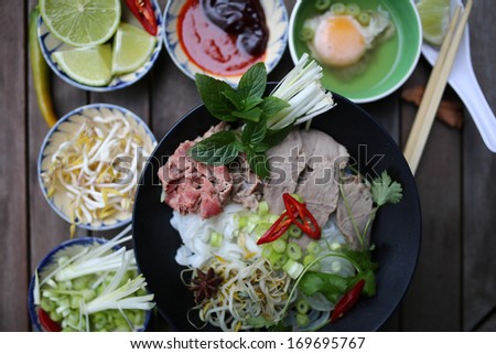 Preparing Vietnamese rice noodles, with beef and other materials