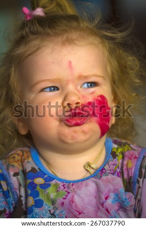 little girl at home mom\'s lipstick smeared themselves