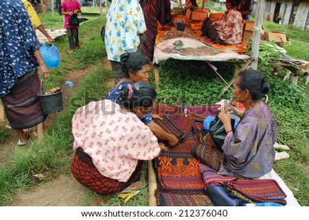 FLORES, INDONESIA-SEPTEMBER 22: women of minority ethnic group selling traditional clothes in the colorful market of Moni on September 22, 2009 in Moni, Flores, Indonesia.