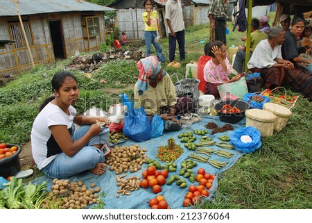 FLORES, INDONESIA-SEPTEMBER 22: women of minority ethnic group selling tomatoes and other vegetables in the colorful market of Moni on September 22, 2009 in Moni, Flores, Indonesia.