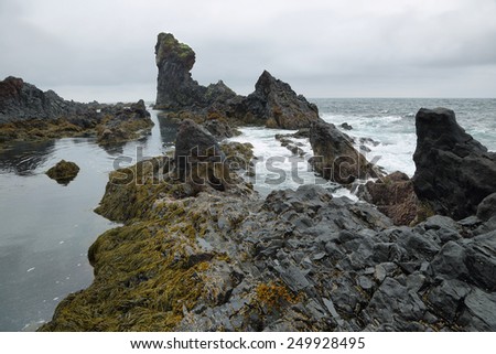 Rock formations in black sand beach of Djupalonssandur, Snaefellsnes peninsula, Iceland