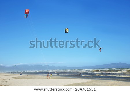 MUIZENBERG, SOUTH AFRICA - DECEMBER 5: Kite surfers training a day with strong winds on December 5, 2014 in Muizenberg beach, South Africa