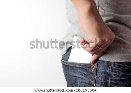 Closeup man pulling a card on his back pocket, Blank card with copy space in a pocket of jeans.