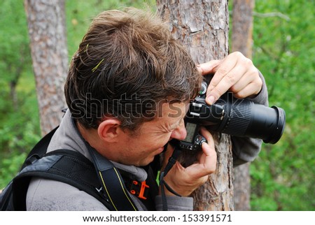 The photographer is shooting from behind the tree.