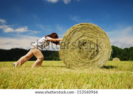 Similar – Image, Stock Photo Woman Pushing Hay Bale