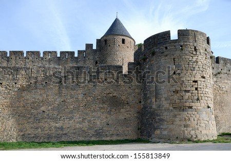 Old defense stone walls with towers of Carcasson castle, France