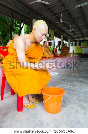 Khonkaen,THAILAND  - April 20: An unidentified Buddhist monk pray near a Buddhist complex in the temple in Khonkaen, Thailand on April 20, 2013
