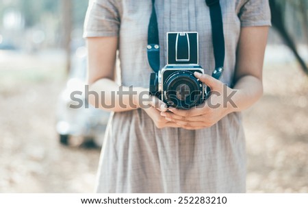 Woman Holding the vintage film camera