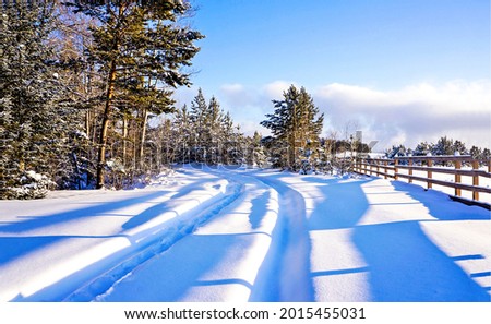 Rural snow road in winter. Winter snow scene. Snowy winter road