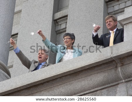 DENVER - APRIL 15: Members of Colorado\'s House, Senate and Aides hold up tea bags during the Tea Party at the Colorado Capitol, April 15, 2009 in Denver.