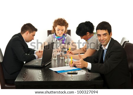Successful business man giving thumb up and sitting at meeting