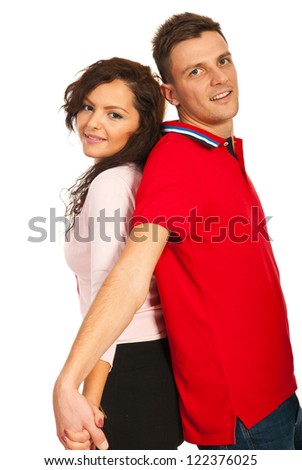Beautiful young couple standing back to back with hands united isolated on white background