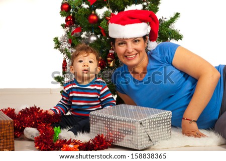 Happy Mother and baby boy celebrate  first Christmas together isolated on white background