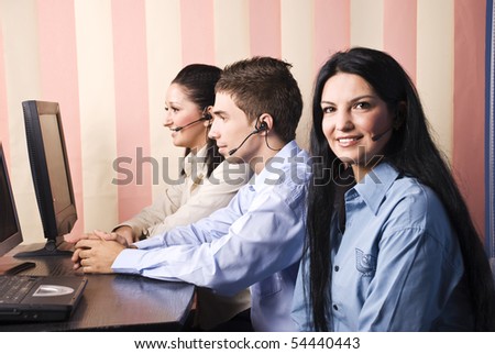 Group of three people customers service in office working,first woman smiling and looking you