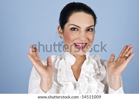 Happy surprised business woman with hands up looking you on blue background