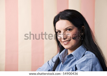 Portrait of beautiful customer serive representative smiling and looking you ,vertical blinds background and copy space for text in left part of image