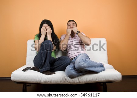 http://image.shutterstock.com/display_pic_with_logo/185902/185902,1275579431,2/stock-photo-couple-watching-tv-a-horror-movie-woman-cover-eyes-to-not-see-anymore-while-the-young-man-are-54961117.jpg