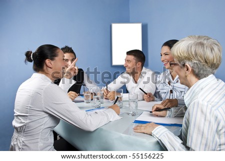 Business group having a meeting and they discuss and laughing together,blank chart for presentation in background