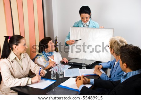 Business woman making a presentation and indicate with pencil on blank board at meeting,copy space for text message
