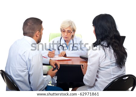 Young couple visiting senior doctor woman in office and having conversation isolated on white background