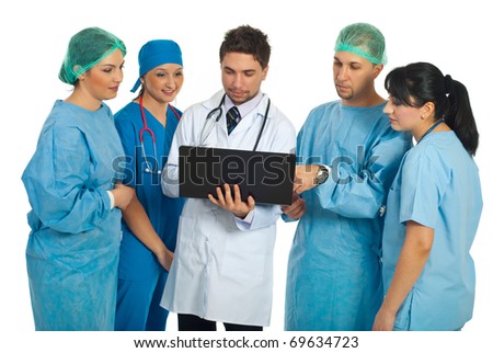Hospital director man with laptop showing something to a surgeons team isolated on white background