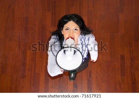 Top  view of business woman shouting in megaphone and looking up