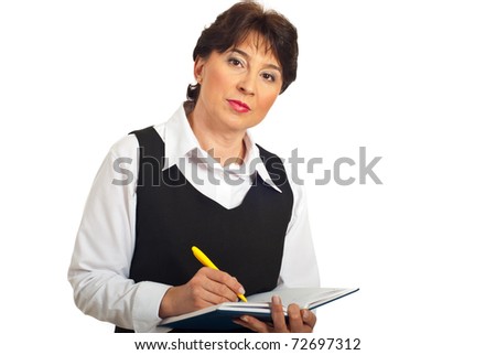 Serious manager woman taking notes in personal agenda isolated on white background