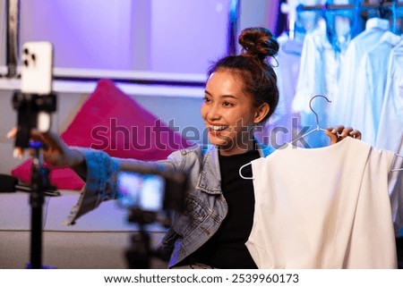 Similar – Foto Bild Trendy asiatische Frau sitzt auf Metallfass in dunklem Studio