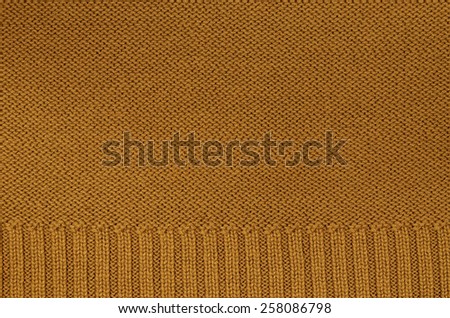 close up of a rust colored knitted background pattern, knitted right and left, detail / Rust colored knitted Background Pattern