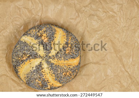 close up of a poppy seed rolls on greaseproof paper, detail, macro, full frame, horizontal / Poppy Seed Roll