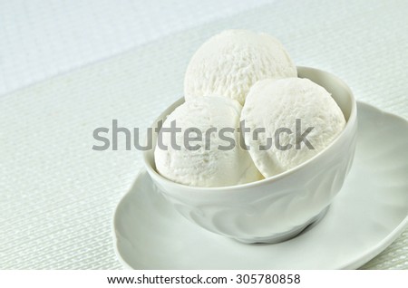 close up of a white bowl with vanilla ice cream and strawberries, macro, detail, horizontal, slanted / Vanilla Ice Cream in a Bowl
